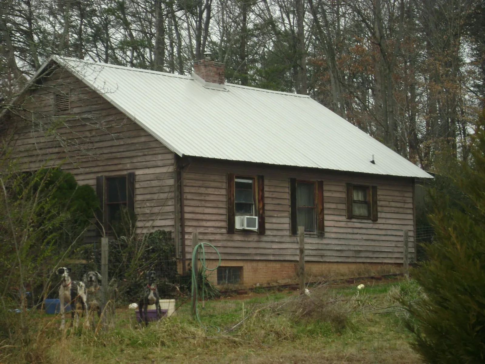White metal roof on an old wood sided farmhouse, from a Metal Roof Installation job in Griswold